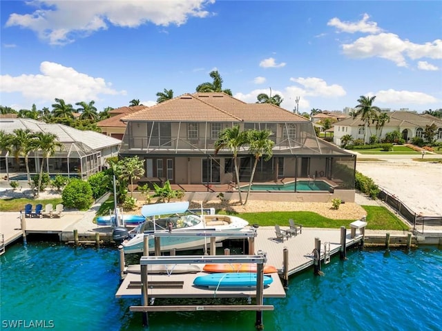 view of dock featuring glass enclosure, a water view, and a patio