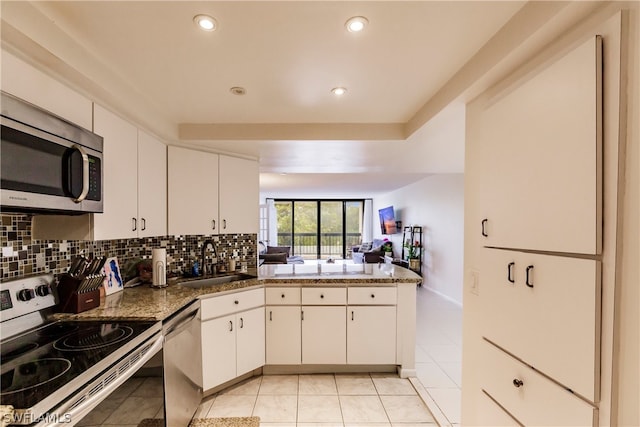 kitchen featuring light tile floors, white cabinets, sink, and stainless steel appliances