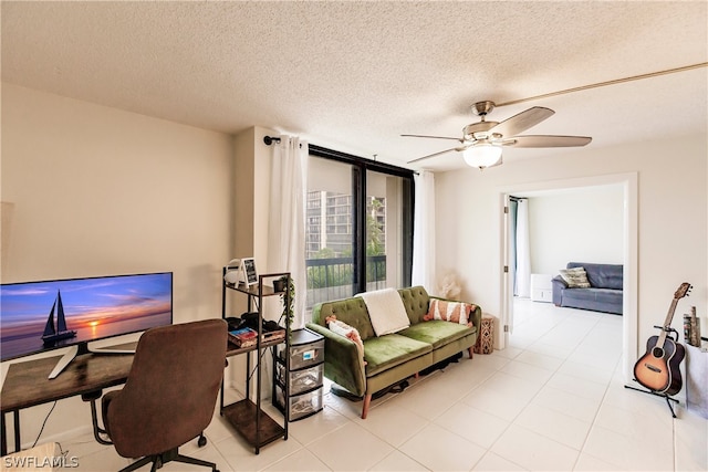 office with a textured ceiling, ceiling fan, and light tile floors