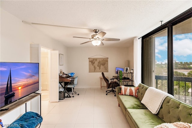 home office featuring light tile floors, a textured ceiling, and ceiling fan