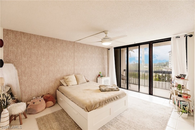 tiled bedroom with a textured ceiling, access to exterior, and ceiling fan