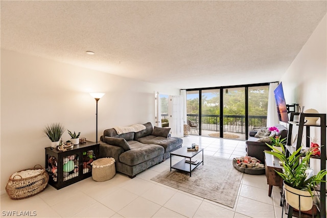 tiled living room with floor to ceiling windows and a textured ceiling