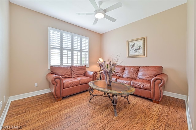 living room featuring light hardwood / wood-style floors and ceiling fan