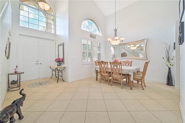 tiled dining space with a notable chandelier and high vaulted ceiling