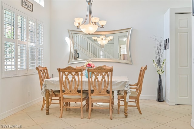 dining space featuring light tile floors and an inviting chandelier