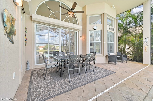 sunroom / solarium featuring ceiling fan