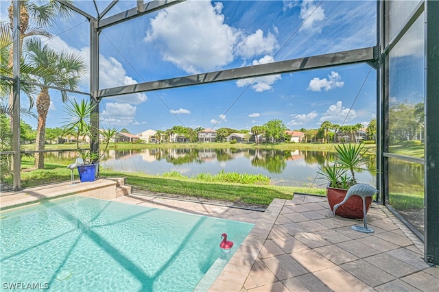 view of pool featuring a water view and a patio area