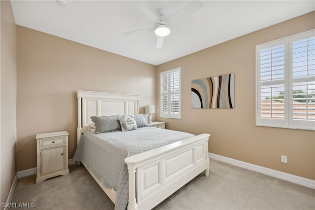 carpeted bedroom with multiple windows and ceiling fan