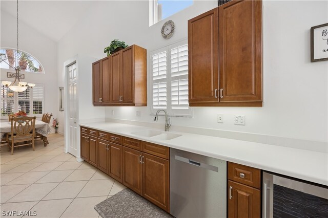 kitchen featuring hanging light fixtures, light tile flooring, a notable chandelier, beverage cooler, and dishwasher