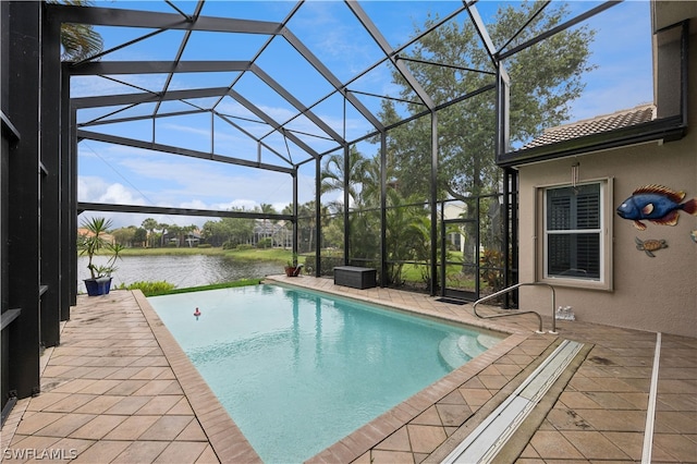 view of pool with glass enclosure, a water view, and a patio