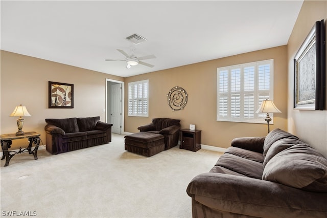 carpeted living room featuring ceiling fan