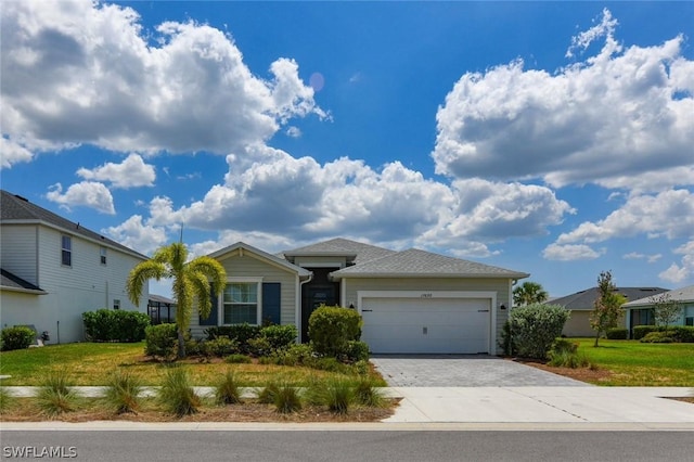 view of front of property with a front yard and a garage