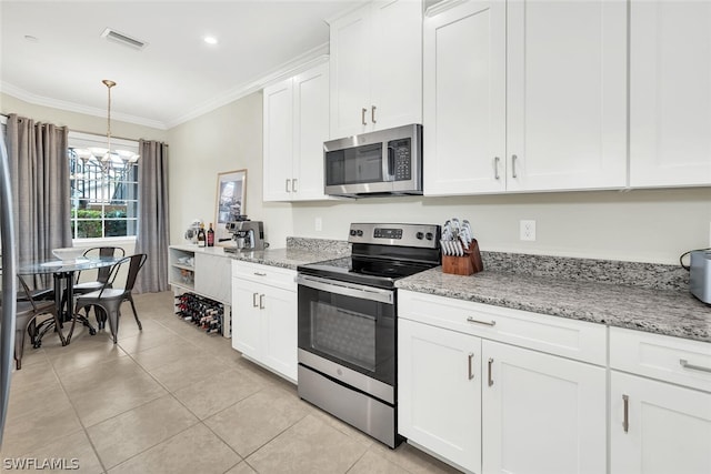 kitchen with appliances with stainless steel finishes, light stone countertops, white cabinetry, and light tile flooring