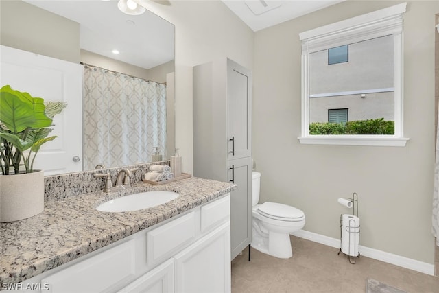 bathroom featuring oversized vanity, ceiling fan, tile floors, and toilet