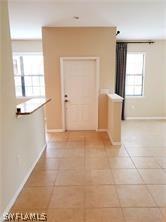 hall with light tile patterned floors