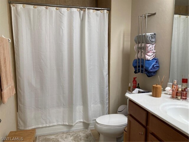 full bathroom with vanity, toilet, and shower / bath combo with shower curtain