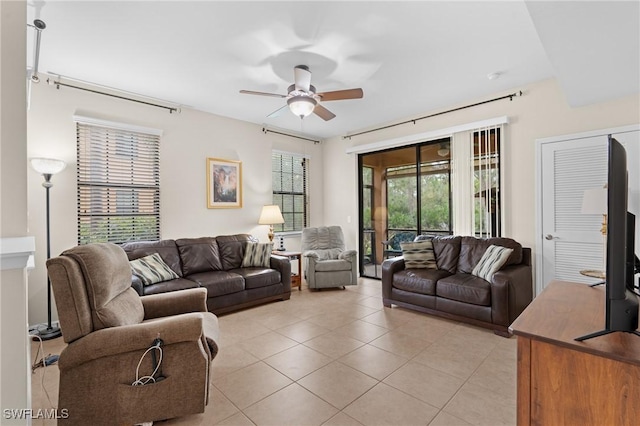 living room with light tile patterned flooring, plenty of natural light, and ceiling fan