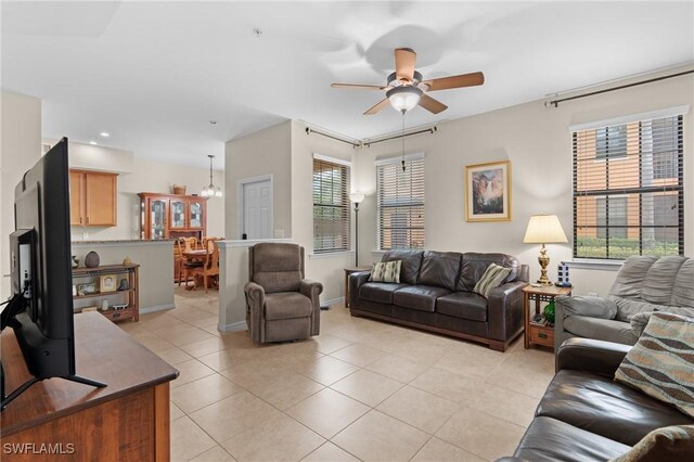 living room featuring light tile patterned floors, plenty of natural light, and ceiling fan