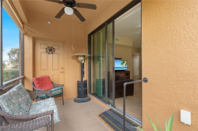 sunroom featuring ceiling fan