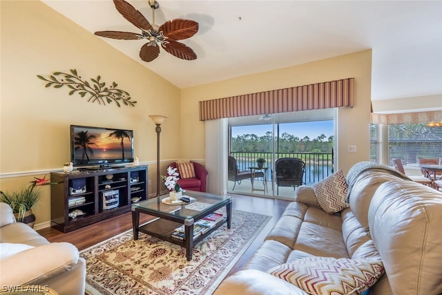 living room with hardwood / wood-style floors, ceiling fan, and lofted ceiling