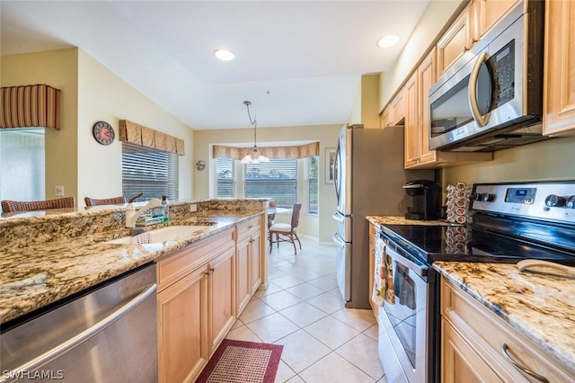 kitchen featuring light stone countertops, decorative light fixtures, a chandelier, and stainless steel appliances