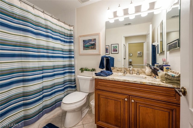 bathroom with vanity, tile floors, and toilet