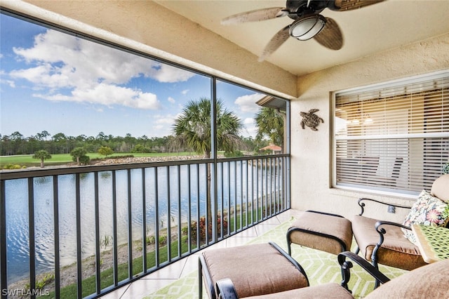 balcony with ceiling fan and a water view