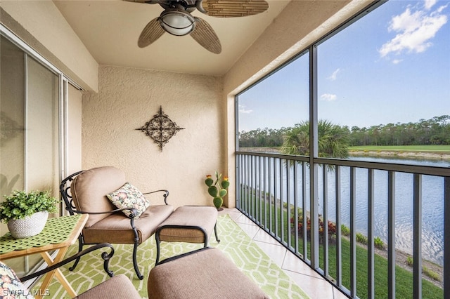 balcony featuring ceiling fan and a water view