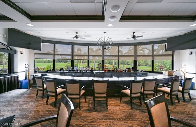 dining space featuring a tray ceiling and ceiling fan with notable chandelier