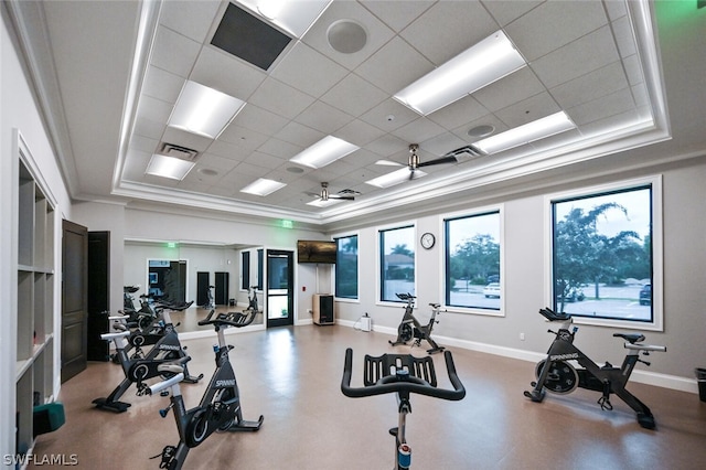 gym with crown molding, a tray ceiling, ceiling fan, and a drop ceiling