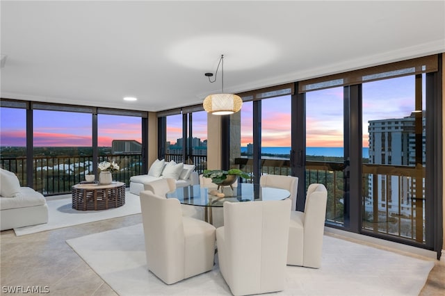 tiled dining area with expansive windows and a water view