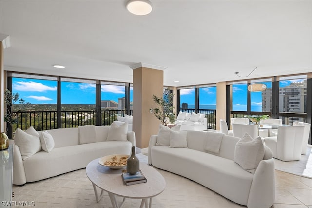 living room featuring floor to ceiling windows and a water view