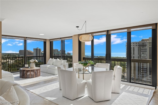 tiled dining room with floor to ceiling windows and a water view