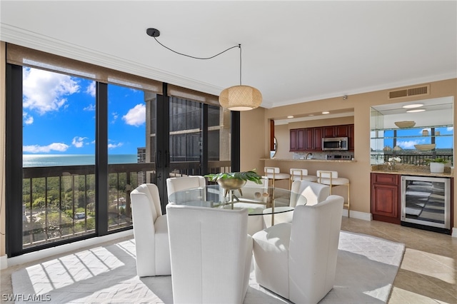 dining area featuring crown molding, light tile flooring, and beverage cooler