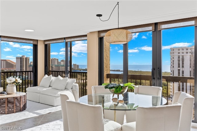 sunroom featuring french doors and a water view