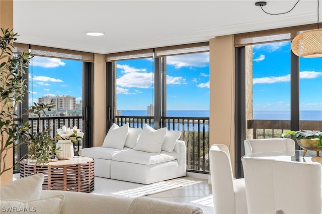 sunroom featuring a wealth of natural light and a water view