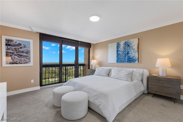 bedroom featuring access to exterior, ornamental molding, light colored carpet, and a wall of windows