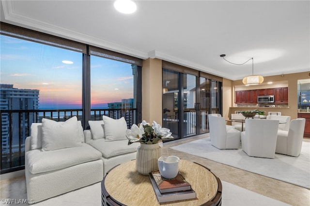 living room with ornamental molding, floor to ceiling windows, and a water view