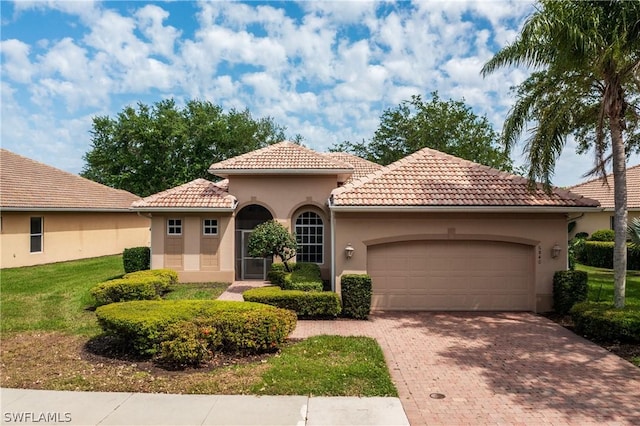 mediterranean / spanish-style home with a garage