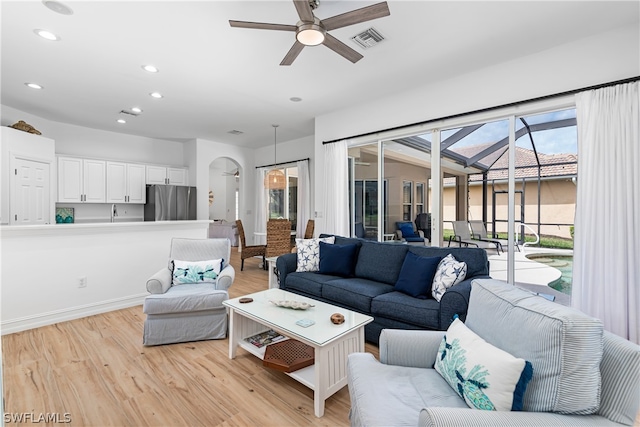 living room featuring ceiling fan and light hardwood / wood-style floors