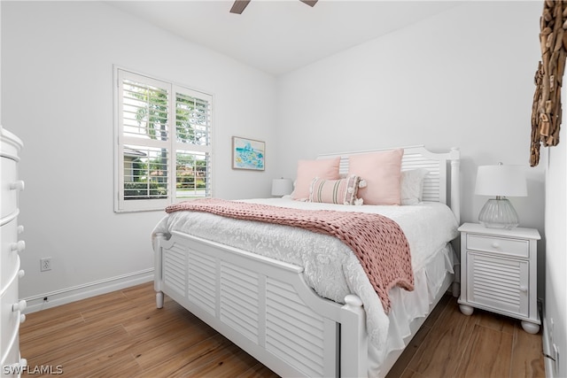 bedroom featuring hardwood / wood-style flooring and ceiling fan