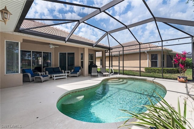 view of pool featuring an outdoor living space, a patio area, ceiling fan, and glass enclosure