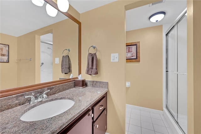 bathroom with vanity, tile patterned flooring, and a shower with door