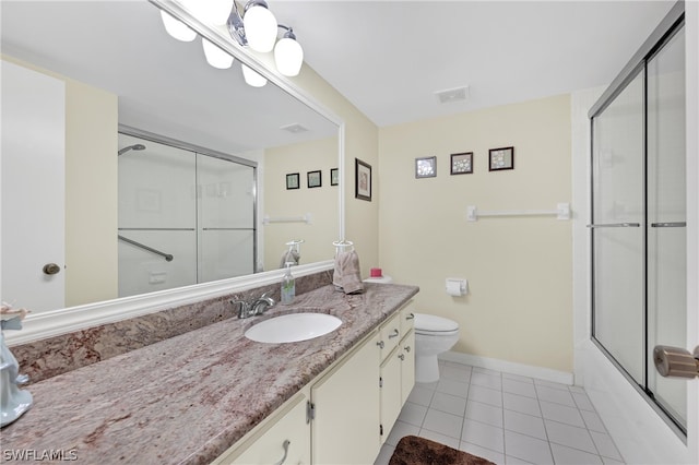 full bathroom with combined bath / shower with glass door, vanity, toilet, and tile patterned flooring