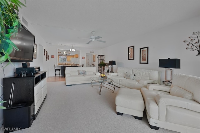 carpeted living room with ceiling fan