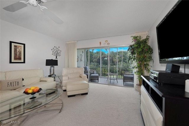 carpeted living room with ceiling fan