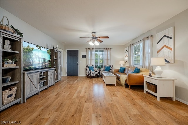 living room featuring light hardwood / wood-style floors and ceiling fan