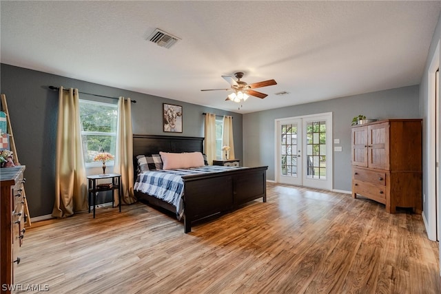 bedroom featuring french doors, access to exterior, ceiling fan, and light wood-type flooring