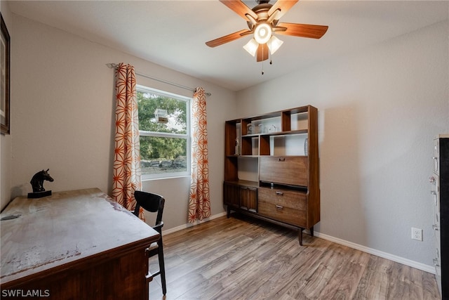 office area with light hardwood / wood-style floors and ceiling fan