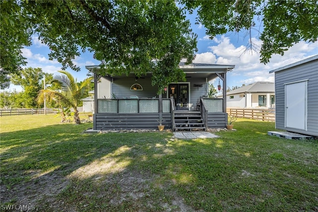 back of house featuring a lawn and a deck